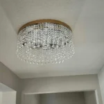 Crystal flush mount chandelier installed in a hallway