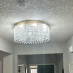 Round crystal ceiling light installed in an entryway