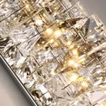 Close-up of clear faceted K9 crystal pieces and warm light reflections on the wall sconce