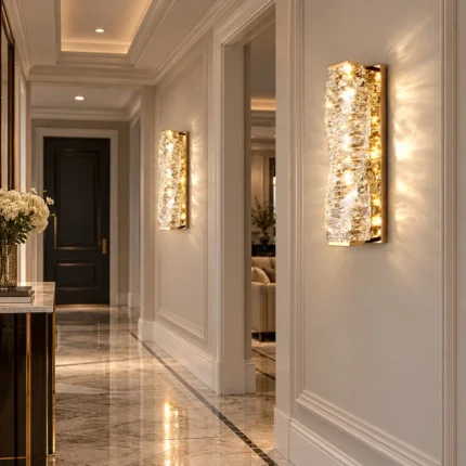 Pair of gold rectangular crystal wall sconces installed along a luxury hallway