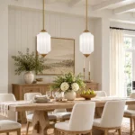 Milk glass pendant lights above a farmhouse dining table