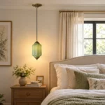 Vintage green glass pendant light beside the bed with antique-style metal details