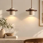 Two natural stone pendant lights with dark wood accents hanging above a stone console in a warm neutral interior.